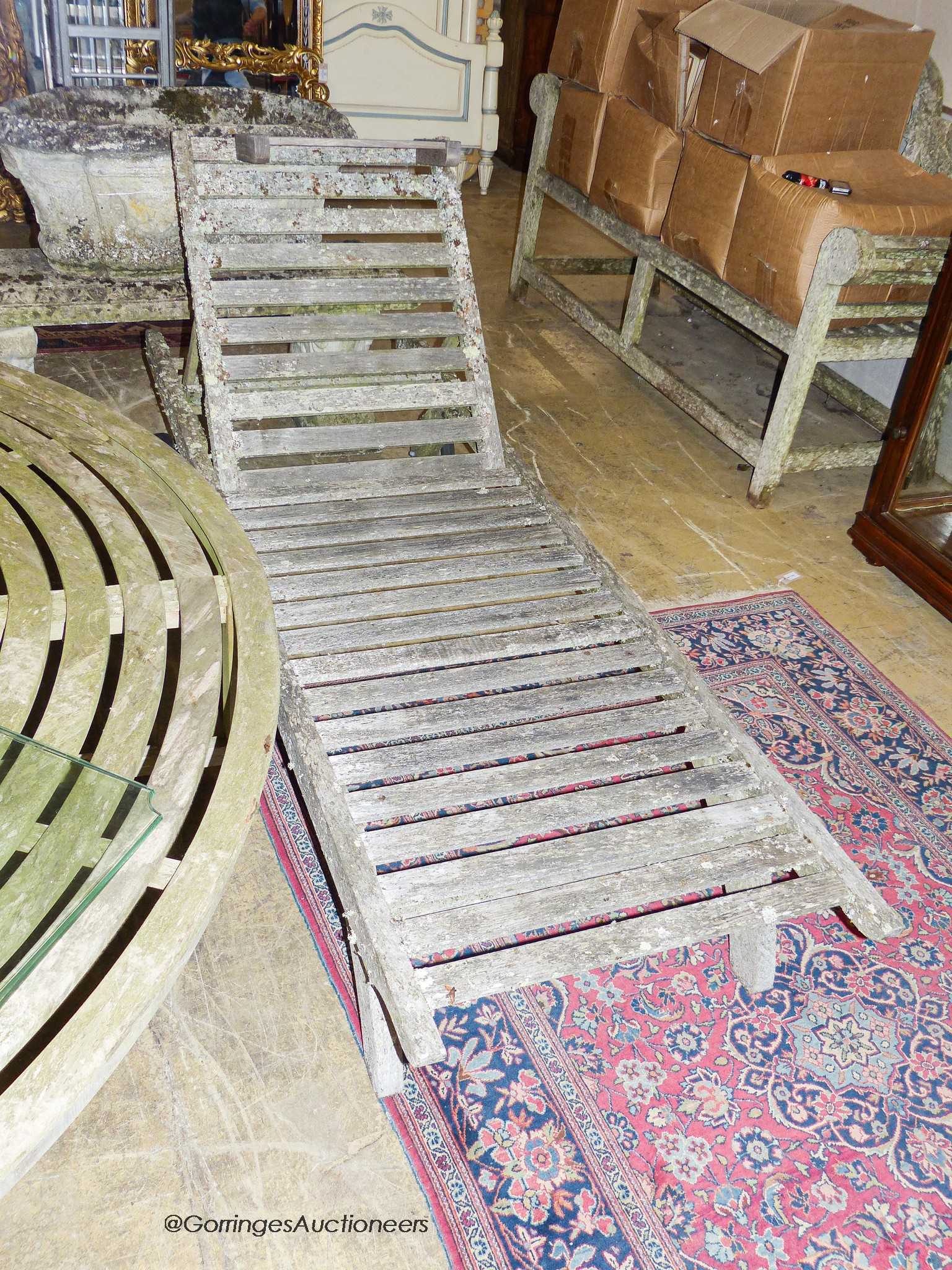 A pair of weathered teak garden loungers, length 198cm